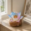 Aurora Lotus balanced glass lotus light on a warm walnut wood base in a calm daytime interior