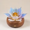 Aurora Lotus balanced glass lotus light with soft blue-white and lavender petals on a warm walnut wood base