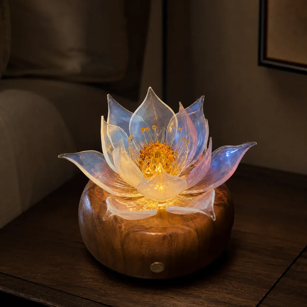Aurora Lotus balanced glass lotus light glowing at night on a warm walnut wood base