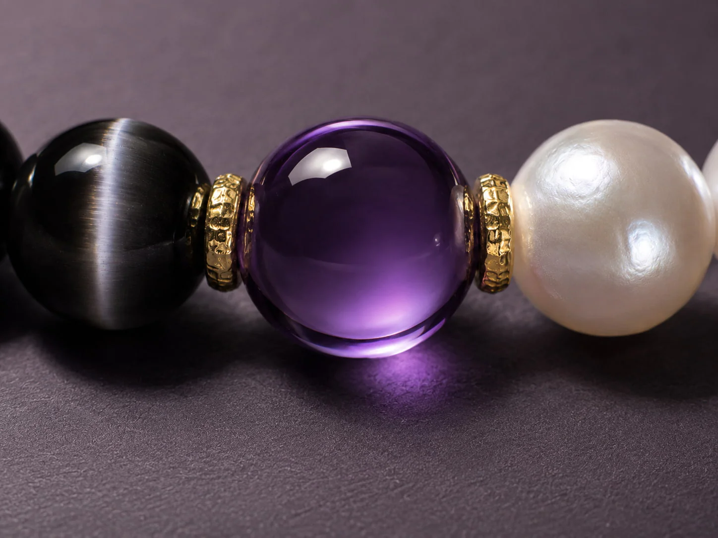 Yin Shadow Balance bracelet with cat’s-eye obsidian, pearl, purple center bead, and 18K gold-plated spacers