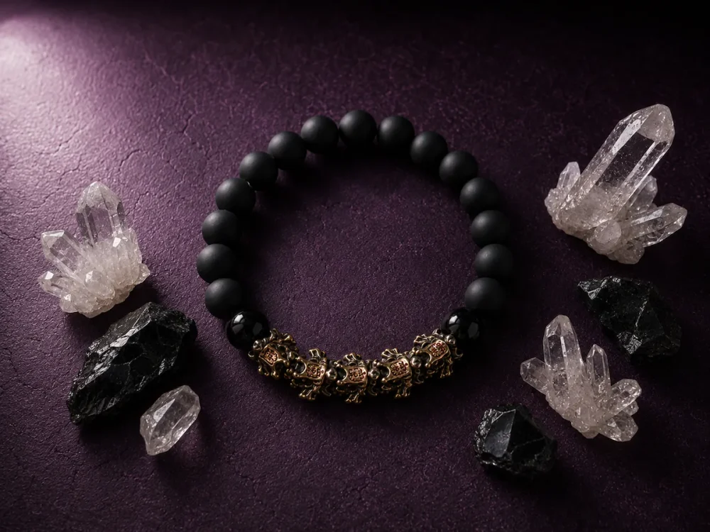 Spiritual advertising poster of 9Purple obsidian bracelet surrounding raw natural clear quartz crystal clusters and black meteorite fragments.