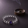 Water Flow bracelet with clear quartz beads, purple amethyst center bead, gold-plated spacers, and incense tray
