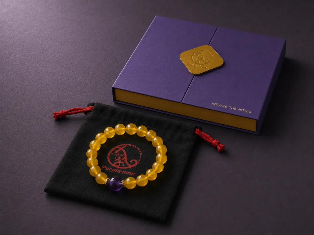 Earth Ground Yellow Agate Amethyst Bracelet Packaging Earth Ground bracelet with yellow agate beads, purple amethyst center bead, purple 9Purple gift box, and black drawstring pouch