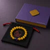Earth Ground Yellow Agate Amethyst Bracelet Packaging Earth Ground bracelet with yellow agate beads, purple amethyst center bead, purple 9Purple gift box, and black drawstring pouch