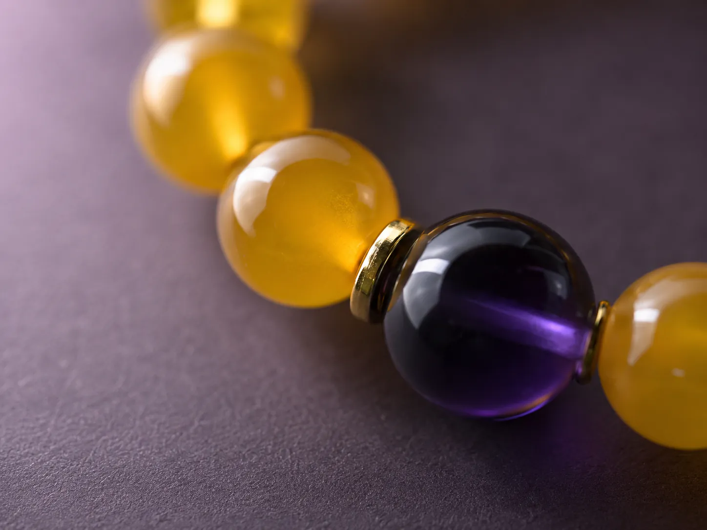 Element Earth Ground yellow agate bracelet with yellow agate, purple center bead, and 18K gold-plated spacers