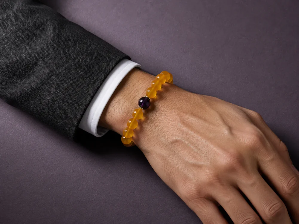 Earth Ground Yellow Agate Amethyst Bracelet Male Wrist Shot Earth Ground bracelet worn on male wrist with yellow agate beads, purple amethyst center bead, and gold-plated spacers