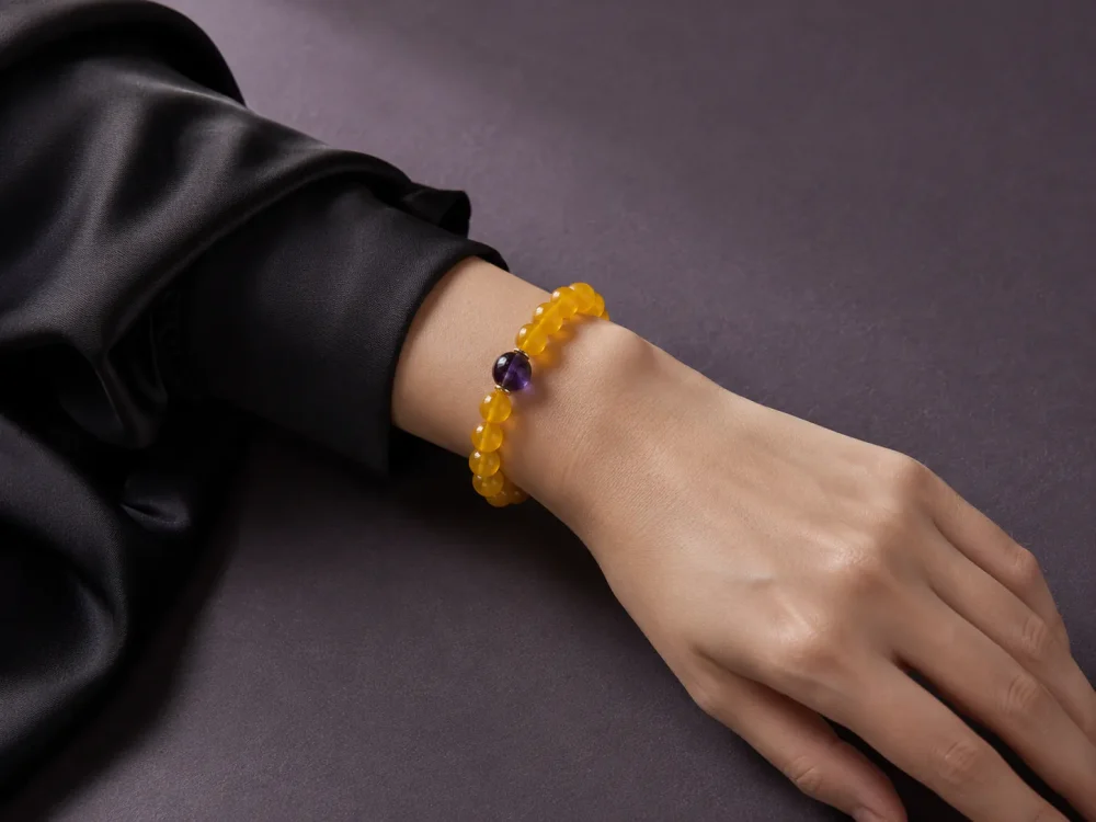 Earth Ground Yellow Agate Amethyst Bracelet Female Wrist Shot Earth Ground bracelet worn on female wrist with yellow agate beads, purple amethyst center bead, and gold-plated spacers