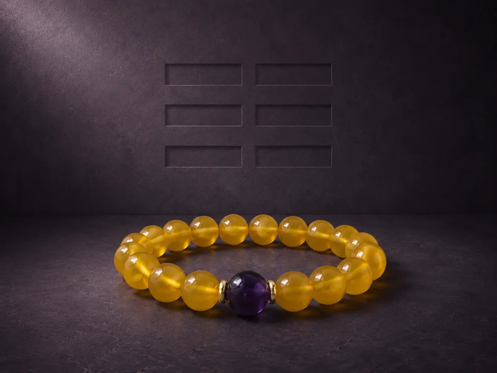 Earth Ground Yellow Agate Amethyst Bracelet Hero Image Earth Ground bracelet with yellow agate beads, purple amethyst center bead, and gold-plated spacers on dark textured background