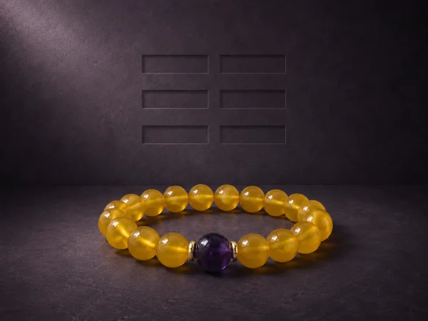 Earth Ground Yellow Agate Amethyst Bracelet Hero Image Earth Ground bracelet with yellow agate beads, purple amethyst center bead, and gold-plated spacers on dark textured background