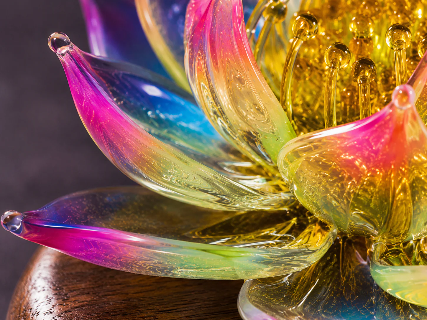 Close view of translucent lampworked glass lotus petals showing layered color and handmade detail
