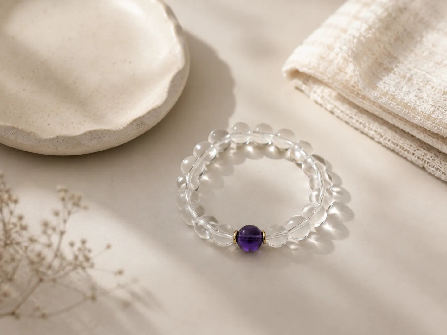 Premium gemstone bracelet resting cleanly on a workspace desk next to a notebook in soft afternoon light shadows