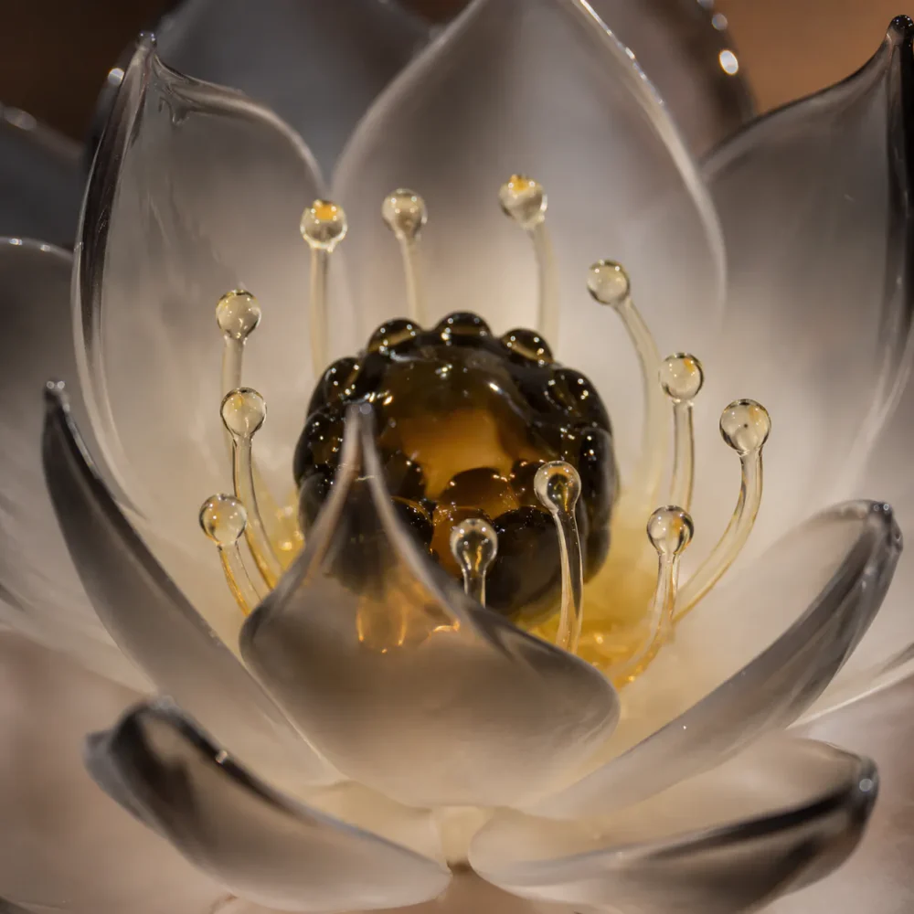 Noir Lotus Dark Amber Glass Center Detail Noir Lotus dark amber glass center with delicate glass stamen and smoky translucent petals