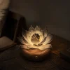 Noir Lotus Night Glow Glass Lotus Light Noir Lotus smoky glass lotus light glowing at night on a warm walnut wood base in a darker room