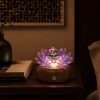 Rosefire Lotus rose-toned glass lotus light glowing at night on a warm walnut wood base