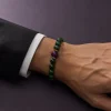 Wood Renewal Ganqing Jade Amethyst Bracelet Male Wrist Shot Wood Renewal bracelet worn on male wrist with Ganqing jade beads, purple amethyst center bead, and gold-plated spacers