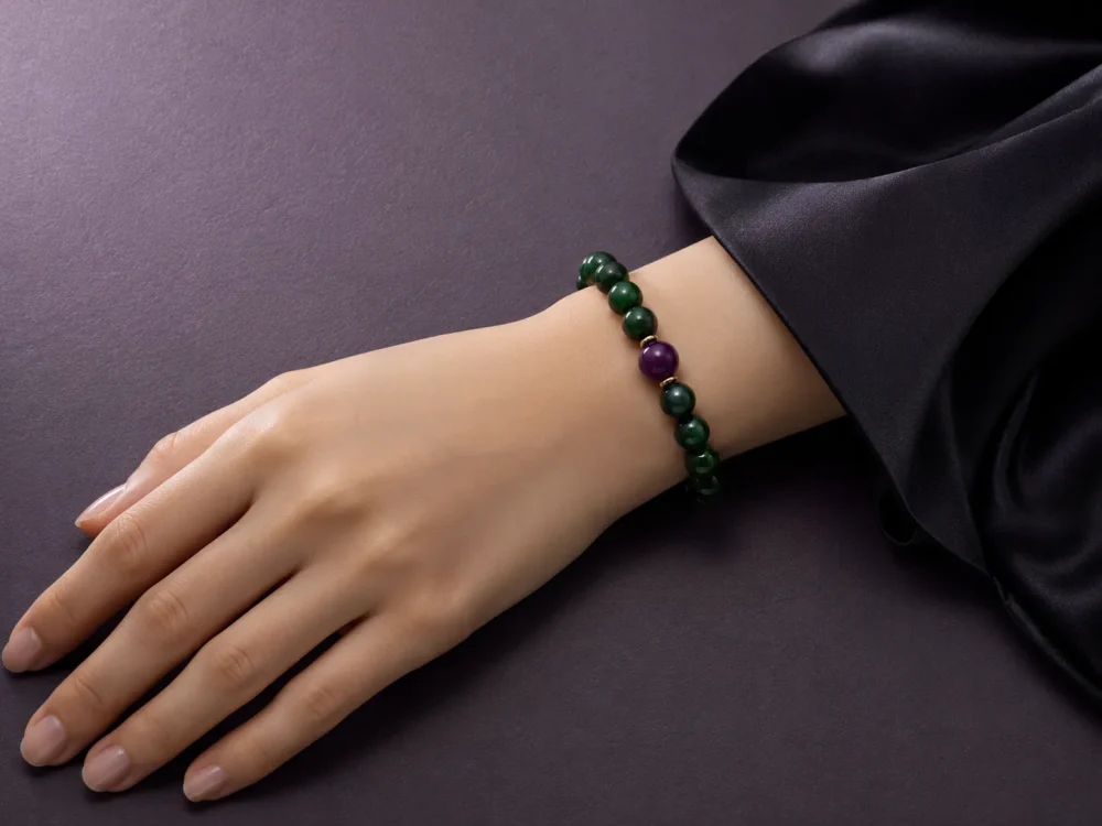Wood Renewal Ganqing Jade Amethyst Bracelet Female Wrist Shot Wood Renewal bracelet worn on female wrist with Ganqing jade beads, purple amethyst center bead, and gold-plated spacers