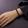 Wood Renewal Ganqing Jade Amethyst Bracelet Female Wrist Shot Wood Renewal bracelet worn on female wrist with Ganqing jade beads, purple amethyst center bead, and gold-plated spacers