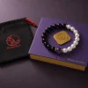 Open 9Purple signature matte-black rigid square gift box revealing custom protective velvet lining and the bracelet.