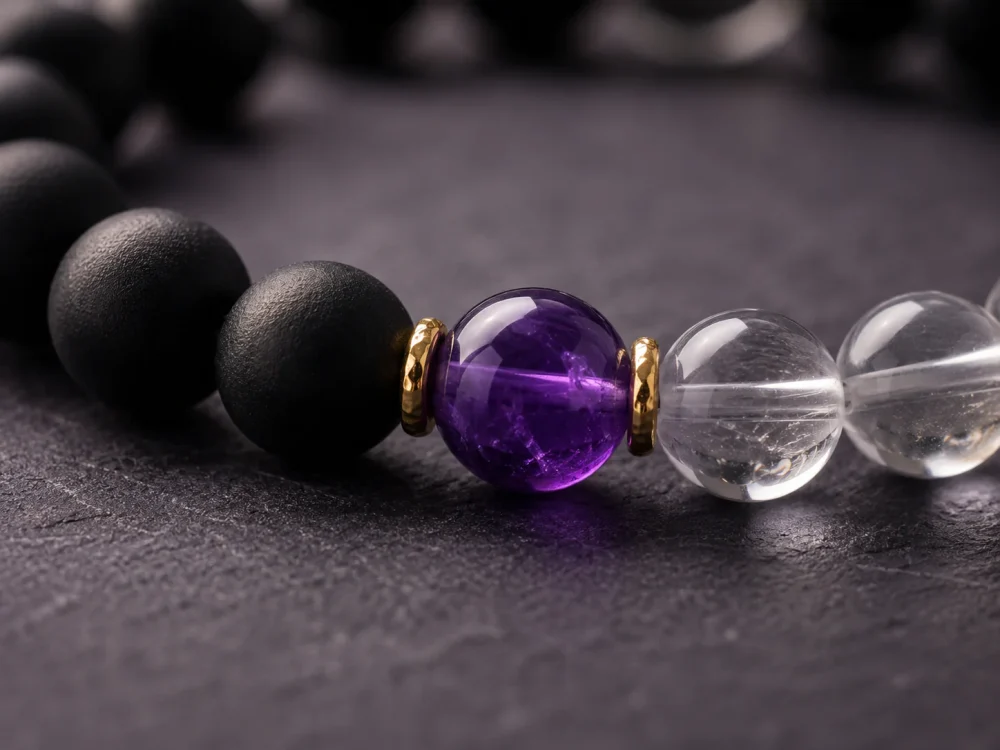 Extreme close-up macro shot of the 9Purple Yin-Yang bracelet showing the rich purple amethyst core and 18k gold plated spacer rings.