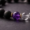 Extreme close-up macro shot of the 9Purple Yin-Yang bracelet showing the rich purple amethyst core and 18k gold plated spacer rings.