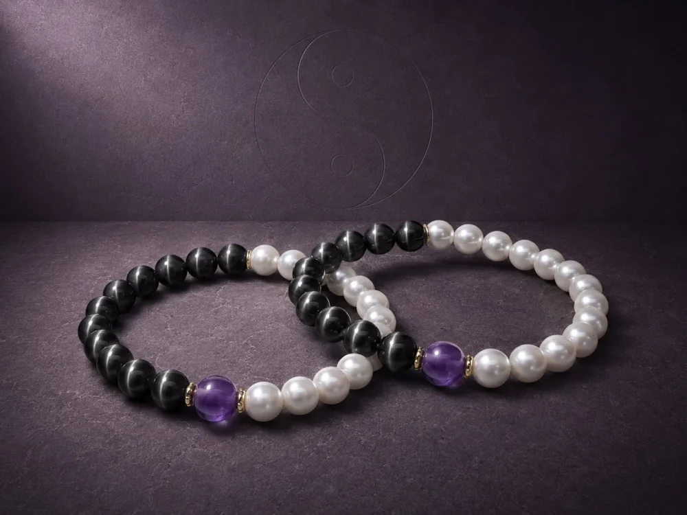 Two 9Purple Yin-Yang luxury protection bracelets displayed together on a premium dark textured surface.