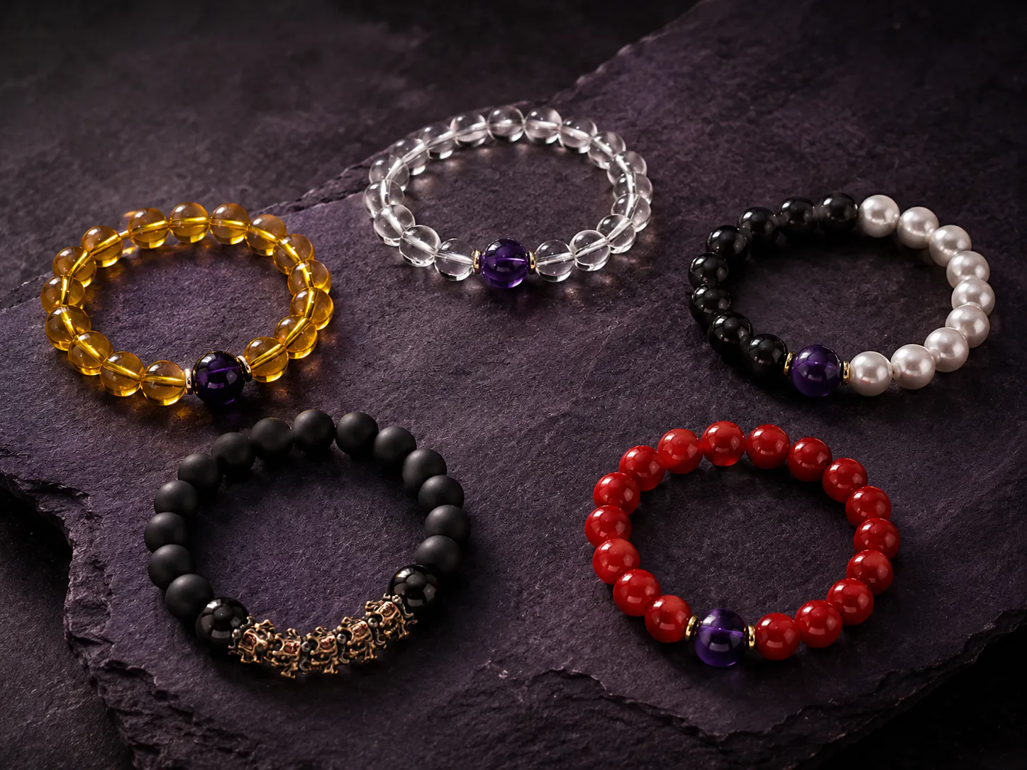 A curated feng shui bracelet collection showing black obsidian white crystal and mixed gemstone textures under directional window light shadows