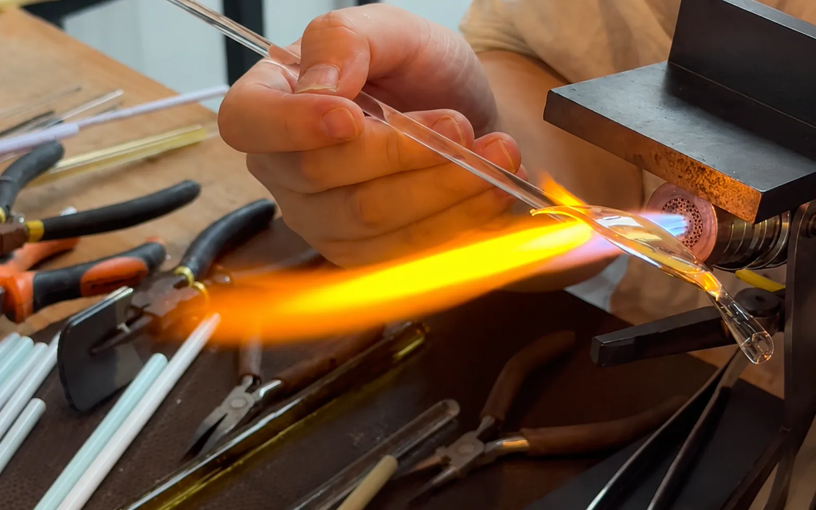 A real borosilicate glass lotus petal being heated in a controlled lampworking flame